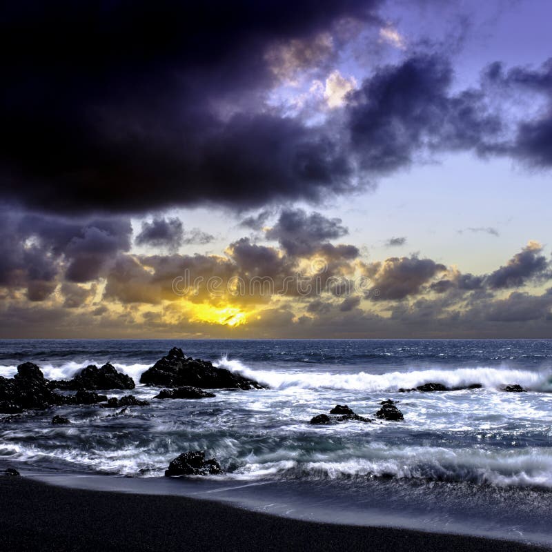 Sunrise over the ocean before storm - black volcanic beach near El Golfo, Lanzarote