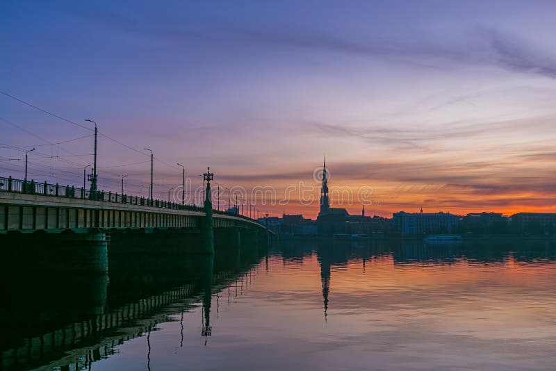 Sunrise over old Riga reflected in the mirror of the Daugava royalty free stock photos