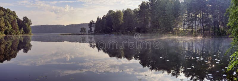 Sunrise over quiet lake Balsys