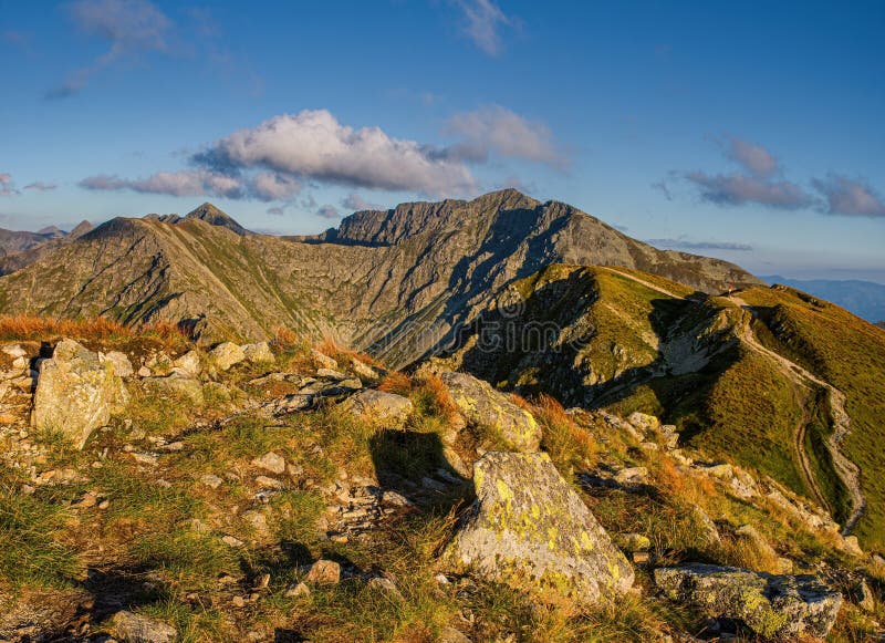 Sunrise from the ridge of the Western Tatras, Rohace with a view of the Salatin mountain with grass illuminated by the rising sun