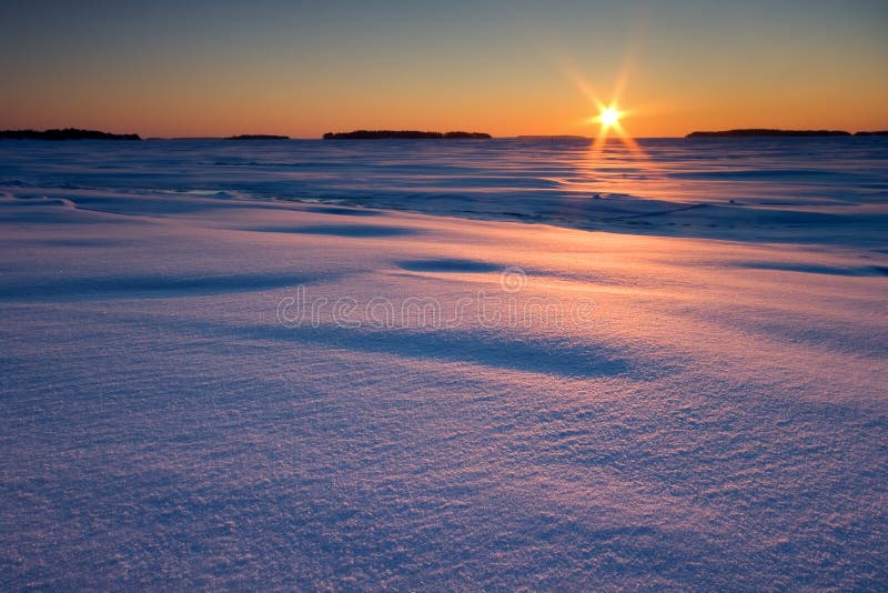 Sunrise and snowy beach