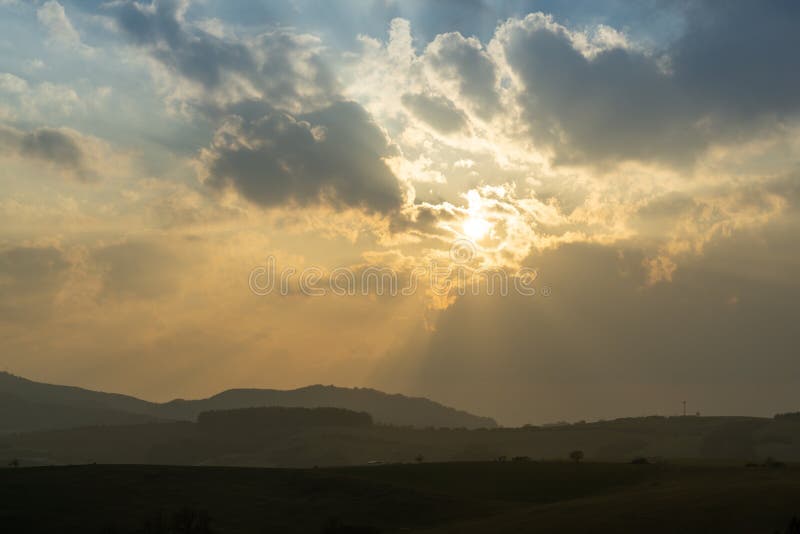 Sunrise or sunset over the hills and meadow.