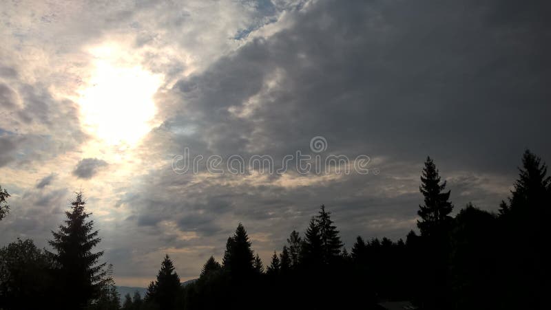 Sunrise or sunset over the hills and meadow.