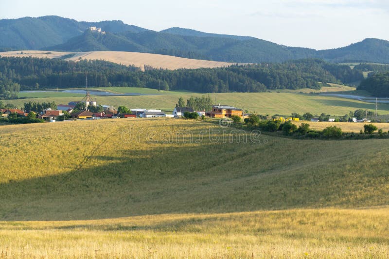 Sunrise or sunset over the hills and meadow.