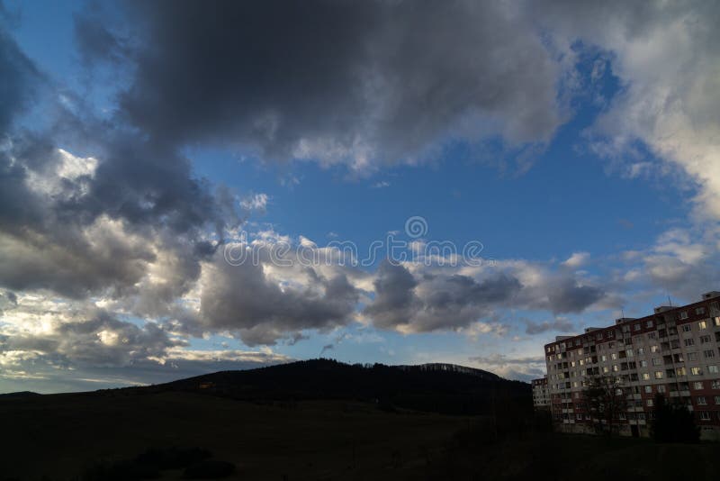 Sunrise or sunset over the hills and meadow.