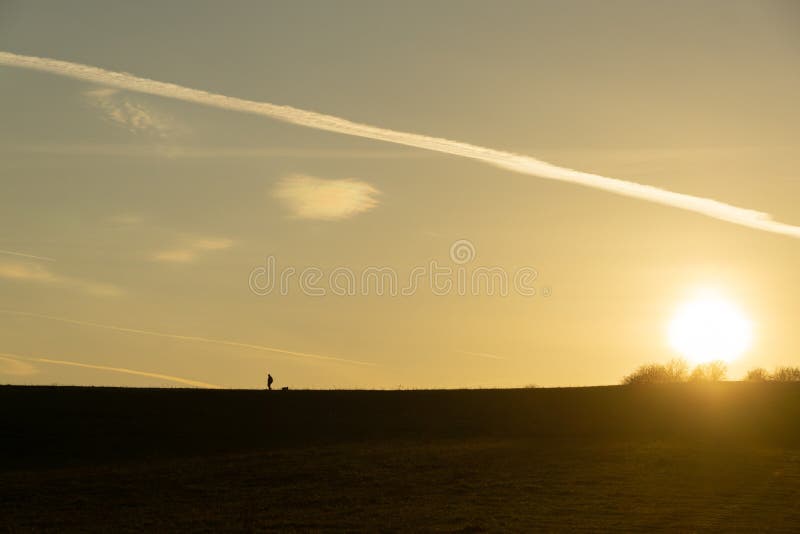 Sunrise or sunset over the hills and meadow.