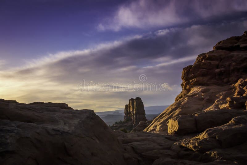 Sunrise under Natural Arch and Purple Sky