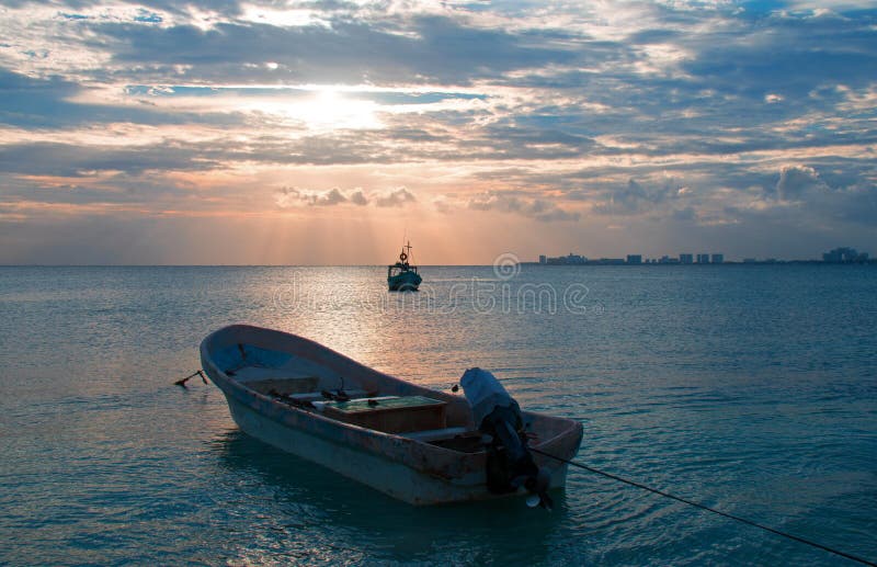 Sunrise View of Mexican Fishing Boat and ponga / skiff in Puerto Juarez Harbor of Cancun Bay