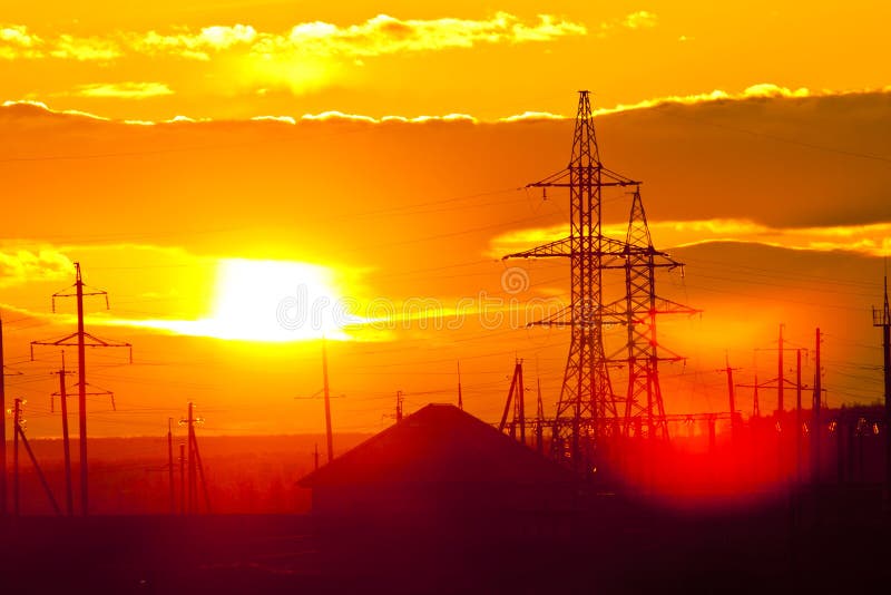 Village and power line against red sunset. Red pylons stock images, royalty-free photos and pictures