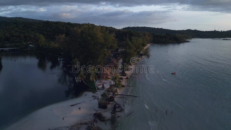 Sunset Beach bar party evening on island. Breathtaking aerial view flight drone