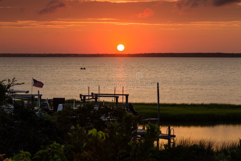 Sunset on Bogue Sound with brilliant orange purple red, American