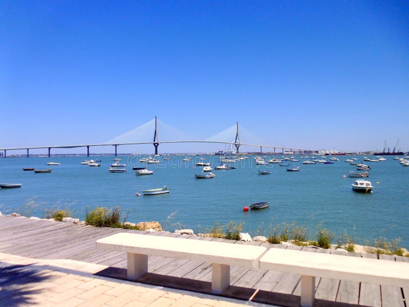 Sunset on the bridge of La Constitucion, called La Pepa, with boat sea in Cadiz, Andalusia. Spain