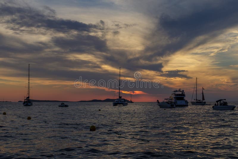 Boats in the sea in front of CafÃ© del Mar at the Spanish Island Ibiza in the mediterranean sea in Europe. CafÃ© del Mar is a famous spot on the island and the best place for sunset. Boats in the sea in front of CafÃ© del Mar at the Spanish Island Ibiza in the mediterranean sea in Europe. CafÃ© del Mar is a famous spot on the island and the best place for sunset.