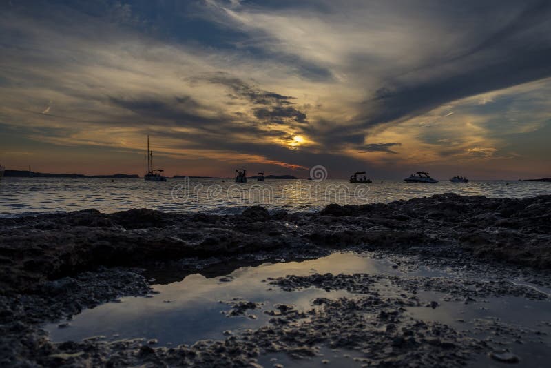 Boats in the sea in front of CafÃ© del Mar at the Spanish Island Ibiza in the mediterranean sea in Europe. CafÃ© del Mar is a famous spot on the island and the best place for sunset. Boats in the sea in front of CafÃ© del Mar at the Spanish Island Ibiza in the mediterranean sea in Europe. CafÃ© del Mar is a famous spot on the island and the best place for sunset.