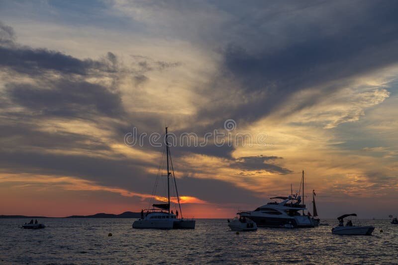 Boats in the sea in front of CafÃ© del Mar at the Spanish Island Ibiza in the mediterranean sea in Europe. CafÃ© del Mar is a famous spot on the island and the best place for sunset. Boats in the sea in front of CafÃ© del Mar at the Spanish Island Ibiza in the mediterranean sea in Europe. CafÃ© del Mar is a famous spot on the island and the best place for sunset.