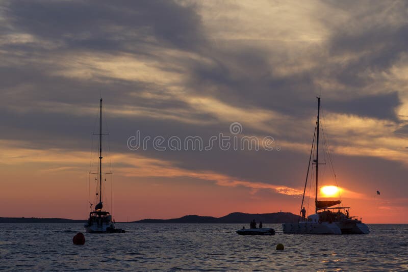 Boats in the sea in front of CafÃ© del Mar at the Spanish Island Ibiza in the mediterranean sea in Europe. CafÃ© del Mar is a famous spot on the island and the best place for sunset. Boats in the sea in front of CafÃ© del Mar at the Spanish Island Ibiza in the mediterranean sea in Europe. CafÃ© del Mar is a famous spot on the island and the best place for sunset.