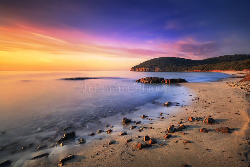 Sunset in Cala Violina bay beach in Maremma, Tuscany. Mediterranean sea. Italy.