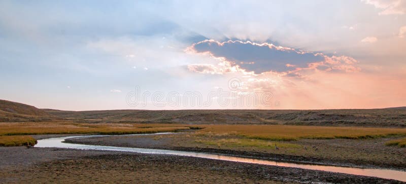 Sunset cloud sun rays at Elk Anter Creek in the Hayden Valley in Yellowstone National Park in Wyoming