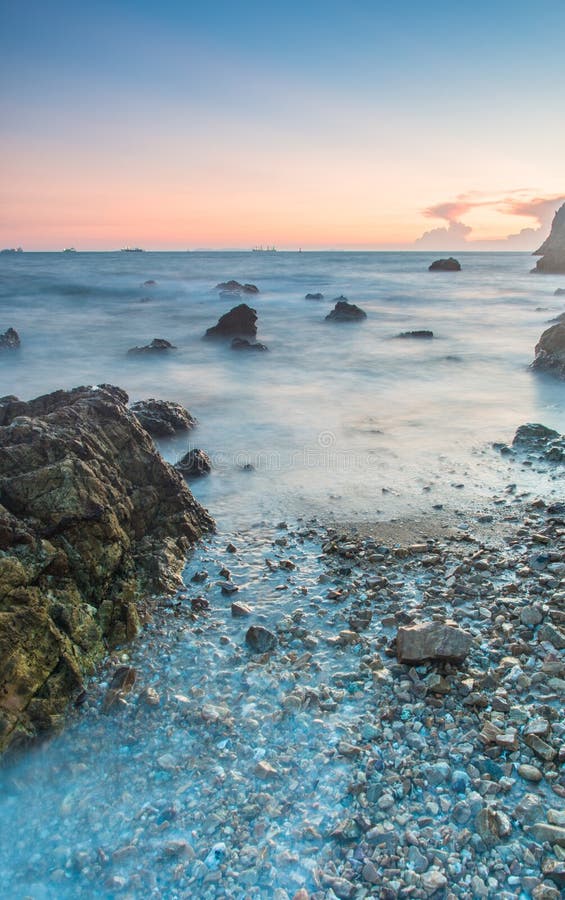 Sunset coastal with rock stone royalty free stock photography