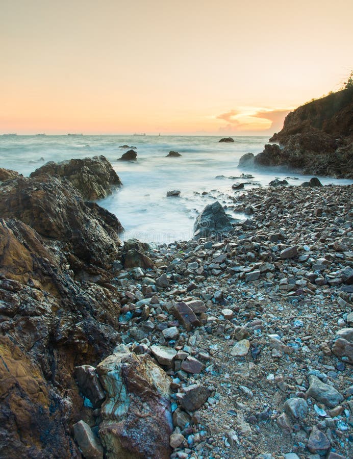 Sunset coastal with rock stone stock image