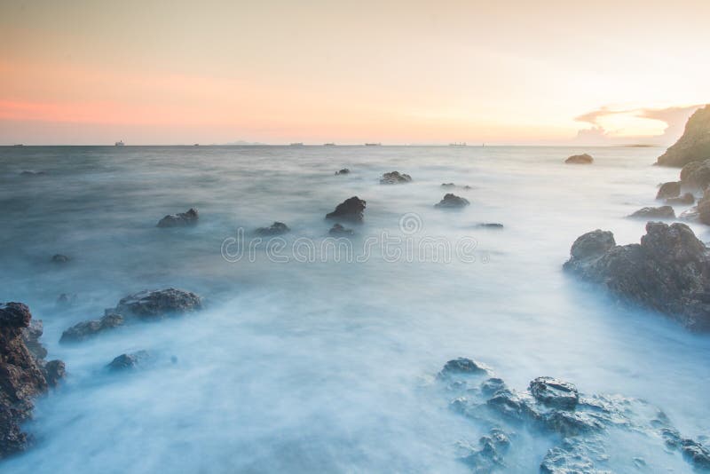 Sunset coastal with rock stone royalty free stock photography