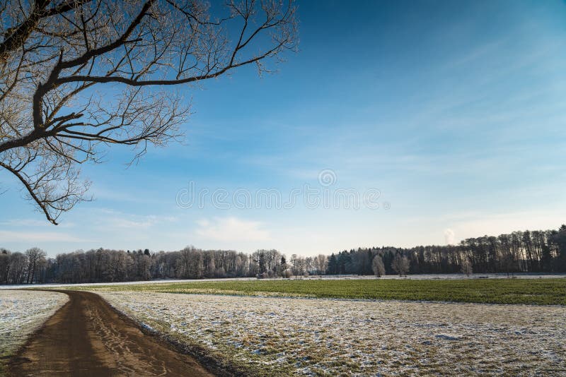 Sunset in a cold white winter day landscape. Road through rural area royalty free stock photo Sunset in a cold white winter day landscape. Road through rural area royalty free stock photo