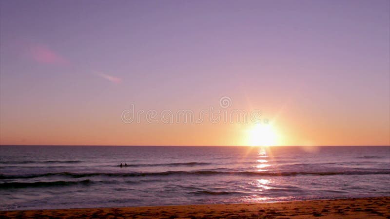 Sunset at Dunas Douradas beach seascape, destination in Algarve, Portugal.