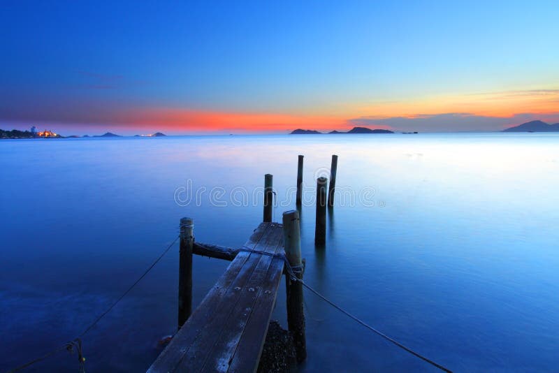 Sunset at dusk along a wooden pier