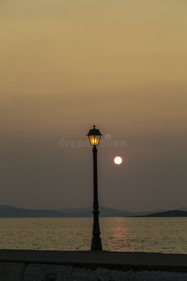 Sunset in a habor with old street light