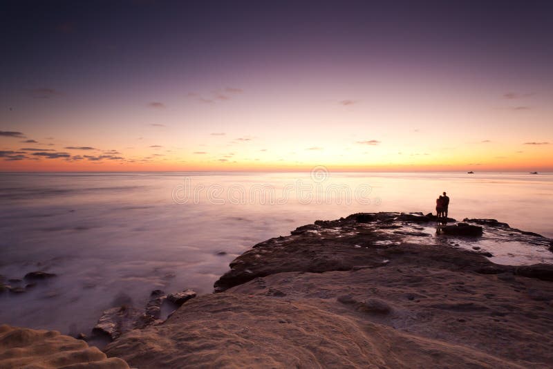 Sunset at La Jolla Cove with silhouette of couple