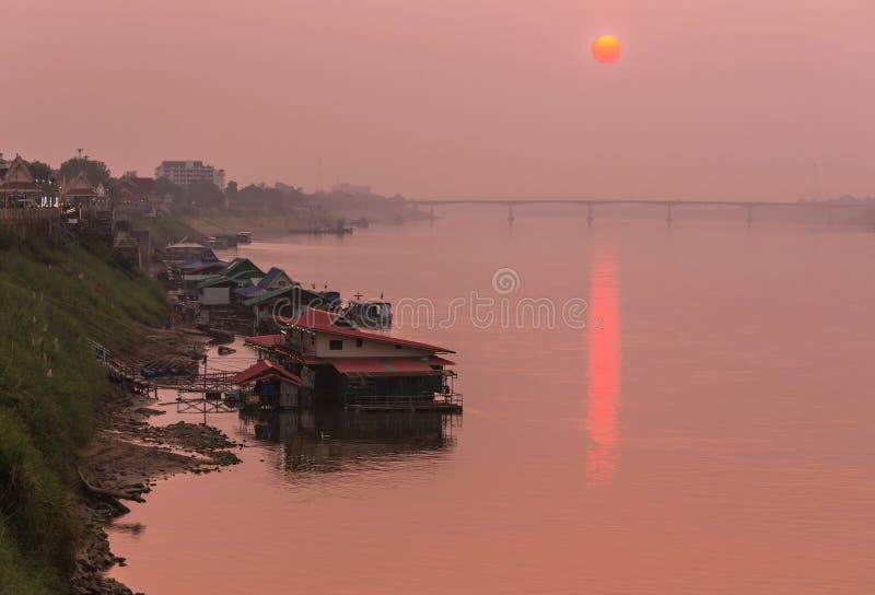 Sunset at the mekong river in Nong Khai province in Thailand with Thai-Lao friendship bridge1st background