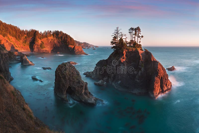 Sunset at Natural Bridges along Samuel H. Boardman State Scenic Corridor, Oregon during a golden hour sunset .