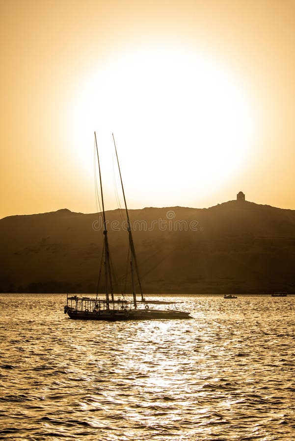 Sunset Nile Aswan and the West Bank with Tombs Old Kingdom Qubbet el-Hawa - `Dome of the Winds` at the crest of the hill stock photo Sunset Nile Aswan and the West Bank with Tombs Old Kingdom Qubbet el-Hawa - `Dome of the Winds` at the crest of the hill stock photo