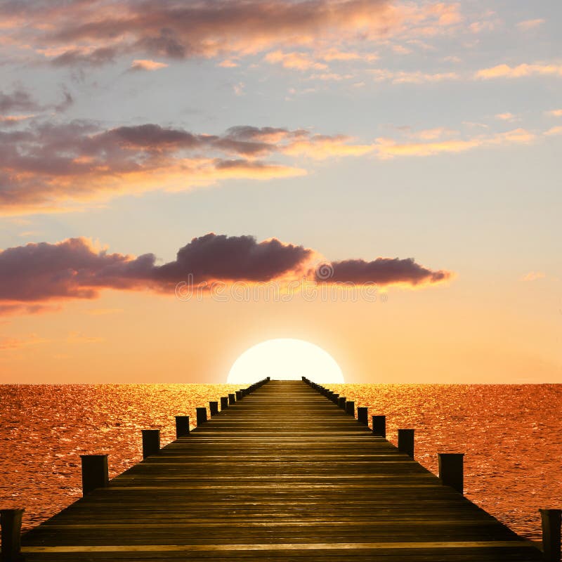 Sunset ocean scenery with wooden boardwalk