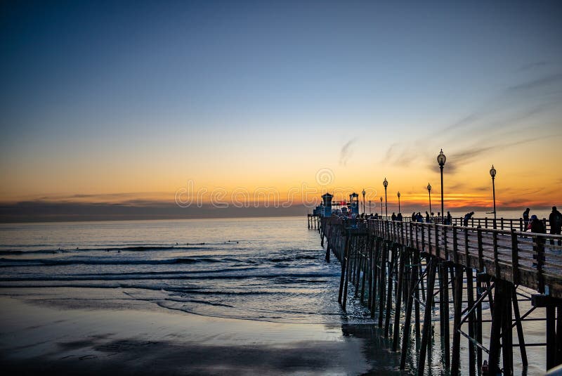 Sunset by Oceanside Pier, Palms and the Pacific Oceanin the famous surf city in California USA stock image Sunset by Oceanside Pier, Palms and the Pacific Oceanin the famous surf city in California USA stock image