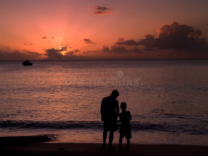 Father and son on the beach at sunset. Father and son on the beach at sunset.