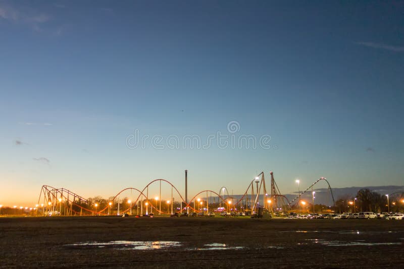 Sunset over an amusement park in a distance