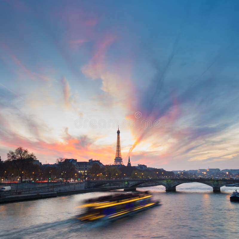Sunset over Eiffel Tower and Seine river.