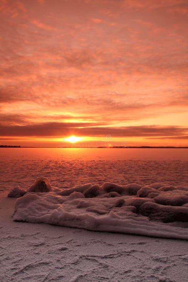 Sunset over frozen lake