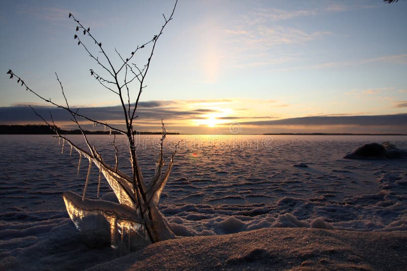 Sunset over frozen lake