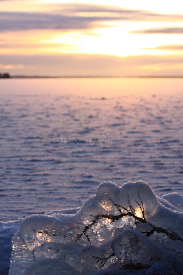 Sunset over frozen lake