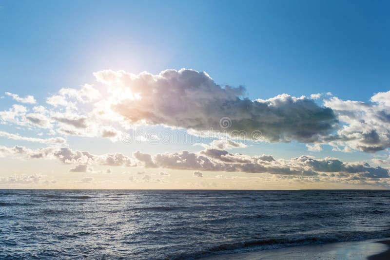 Sunset over the Gulf of Finland in Saint Petersburg. The rays of sun break through the low-hanging clouds