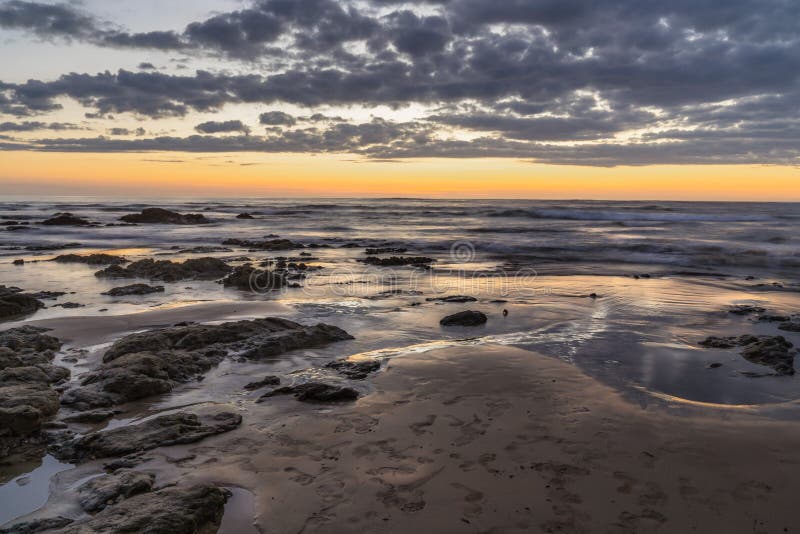 After sunset over the ocean horizon with last light on the beach stock photo After sunset over the ocean horizon with last light on the beach stock photo