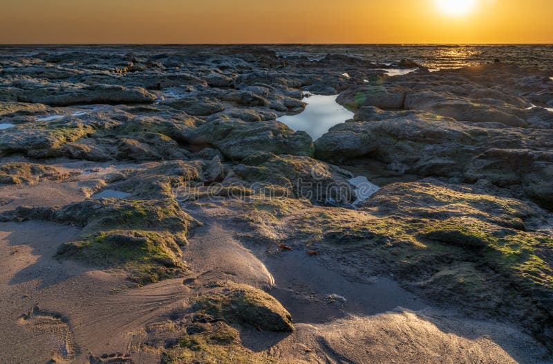 Sunset over the ocean horizon with reflections and sun flares royalty free stock photo Sunset over the ocean horizon with reflections and sun flares royalty free stock photo