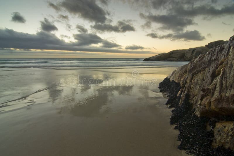 Sunset over rocky beach