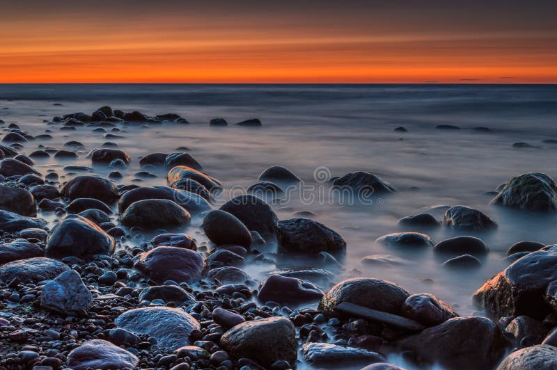 Sunset Over The Sea Stone On The Foreground Stock Image Image Of