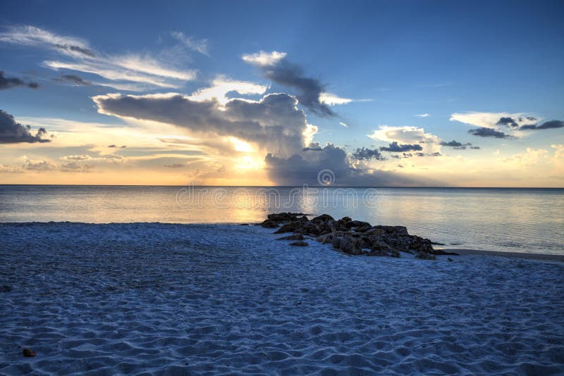 Sunset over the white sand on Naples Beach in Naples, Florida