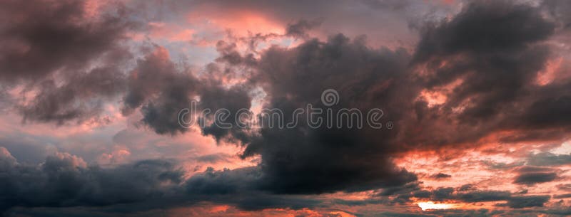 Sunset panorama with raspberry clouds over a small town stock images