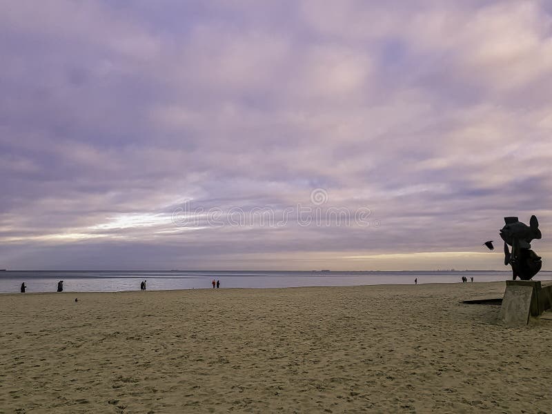 Sunset on Polish coast with fish monument and Baltic Sea in Gdynia royalty free stock photo Sunset on Polish coast with fish monument and Baltic Sea in Gdynia royalty free stock photo