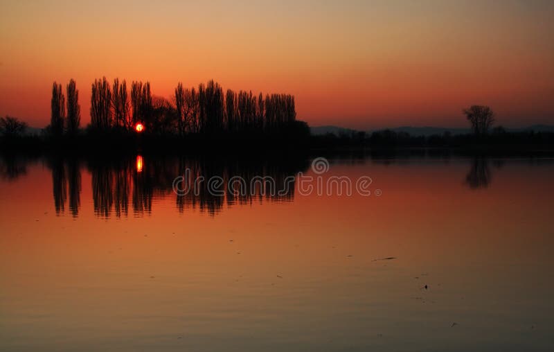 Sunset in pond with orange sky